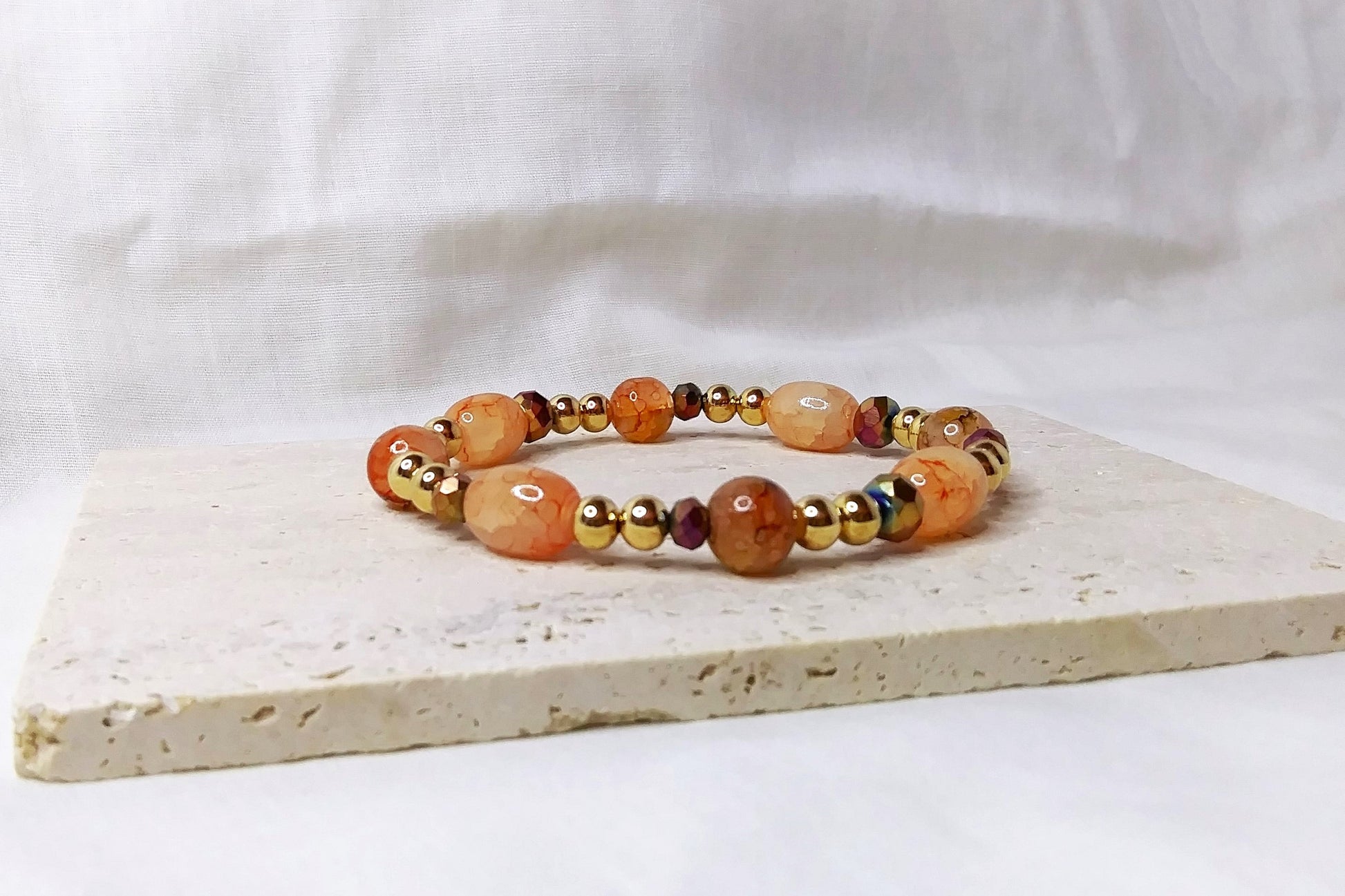 Gold & peach colored beaded stretch bracelet