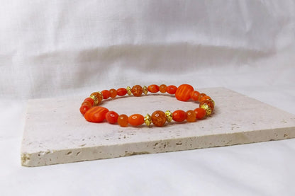 Glass beads and Orange Quartz with gold accent stretch stackable bracelet