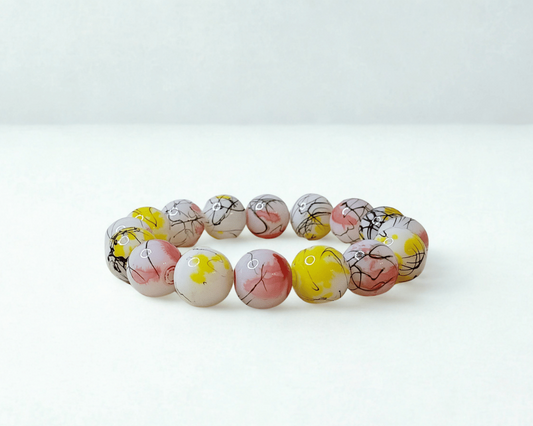 Bracelet with multicolored beads on a white background