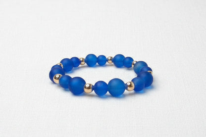 Blue beaded bracelet on a white background
