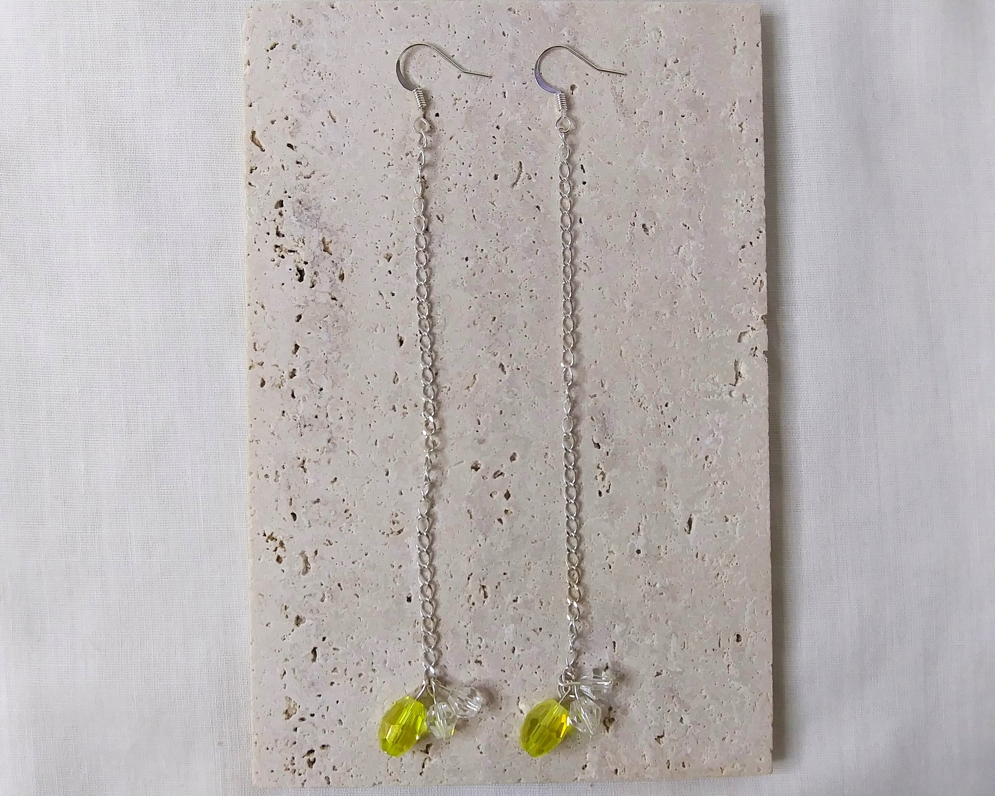 Long silver earring with yellow glass beads