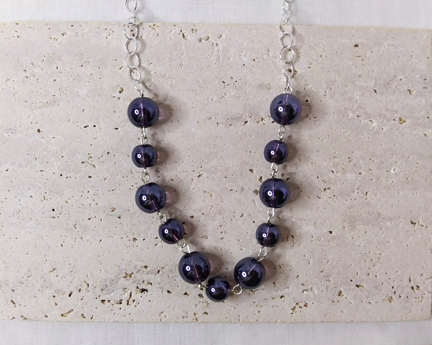 Long silver plated necklace with purple beads